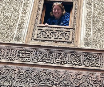 A tourist taking a picture in the Medersa Attarine in Fez